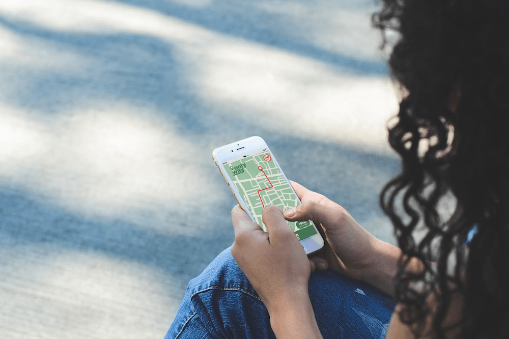 Person holding a smartphone with a GPS map displayed, representing important things to know about GPS tracking for safety and navigation.