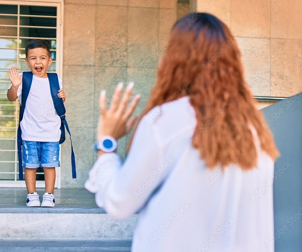 Excited child with backpack waving goodbye to parent wearing GPS smartwatch, highlighting family safety and child tracking.