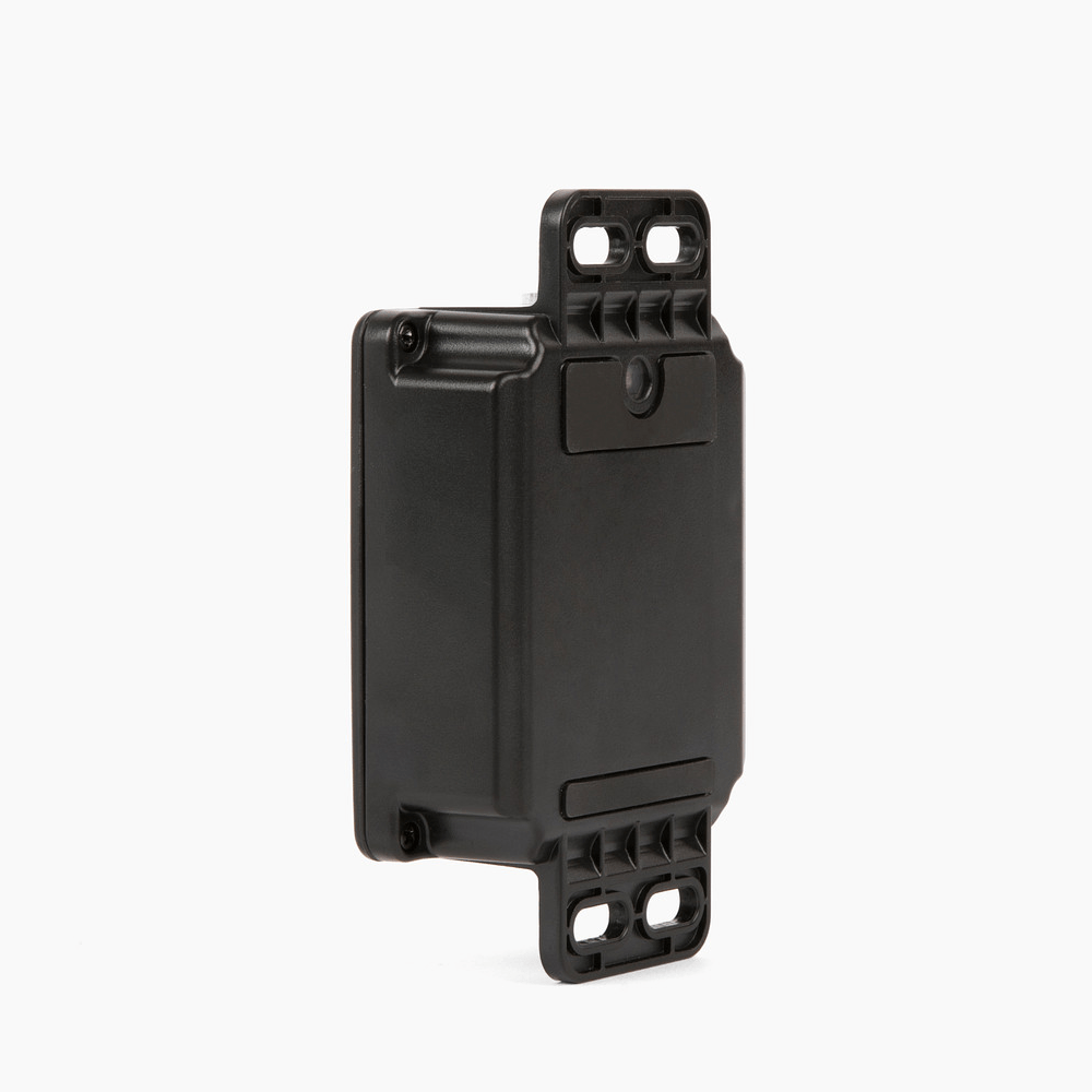 Compact black AssetTrack Mini GPS tracker with mounting brackets, ideal for tracking equipment, vehicles, and assets