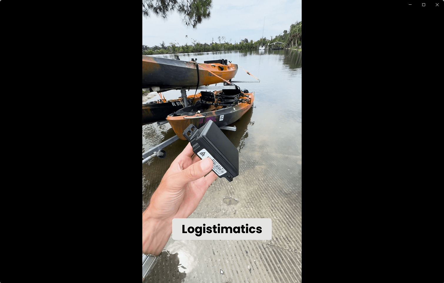 Hand holding a waterproof GPS tracker near kayaks by the water, showing Logistimatics AssetTrack Mini device for outdoor equipment tracking.