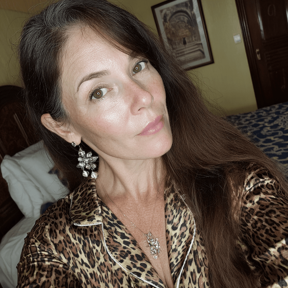 Woman wearing a leopard print top with a blurred background