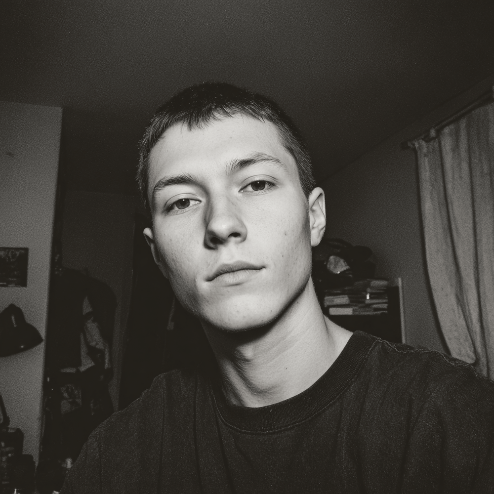 Black and white photo of a person indoors with a neutral expression