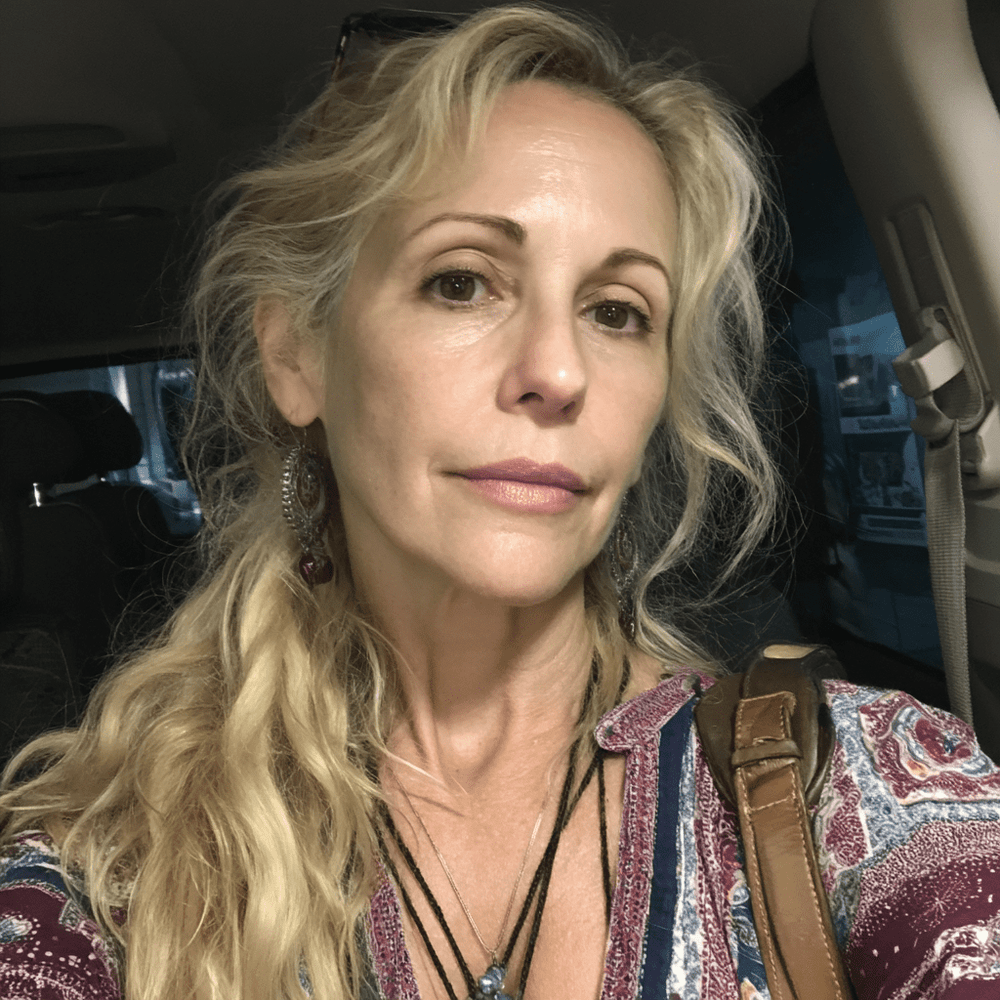 Woman with blonde hair sitting inside a vehicle