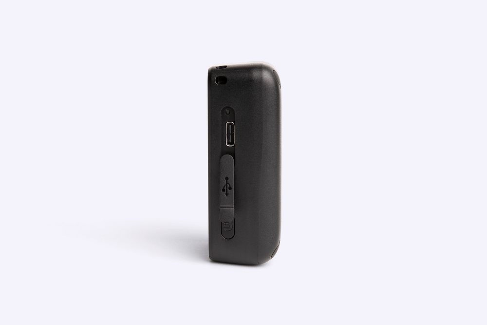 Black GPS device with ports on a white background