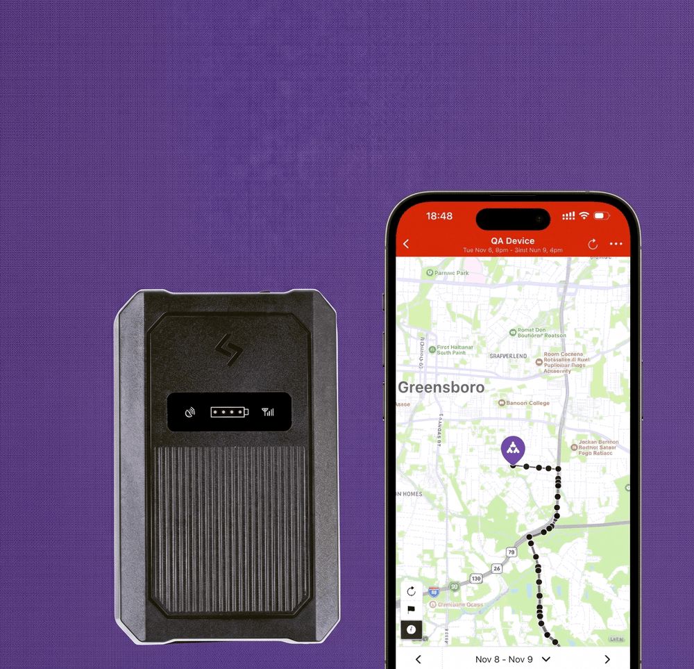 Black GPS tracking device and smartphone with tracking app