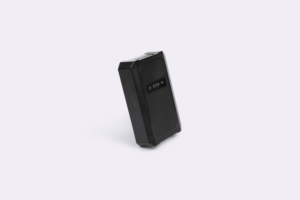 Side view of small black gps tracker.