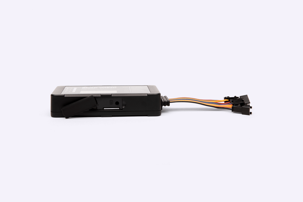 Black GPS device with connectors on a white background