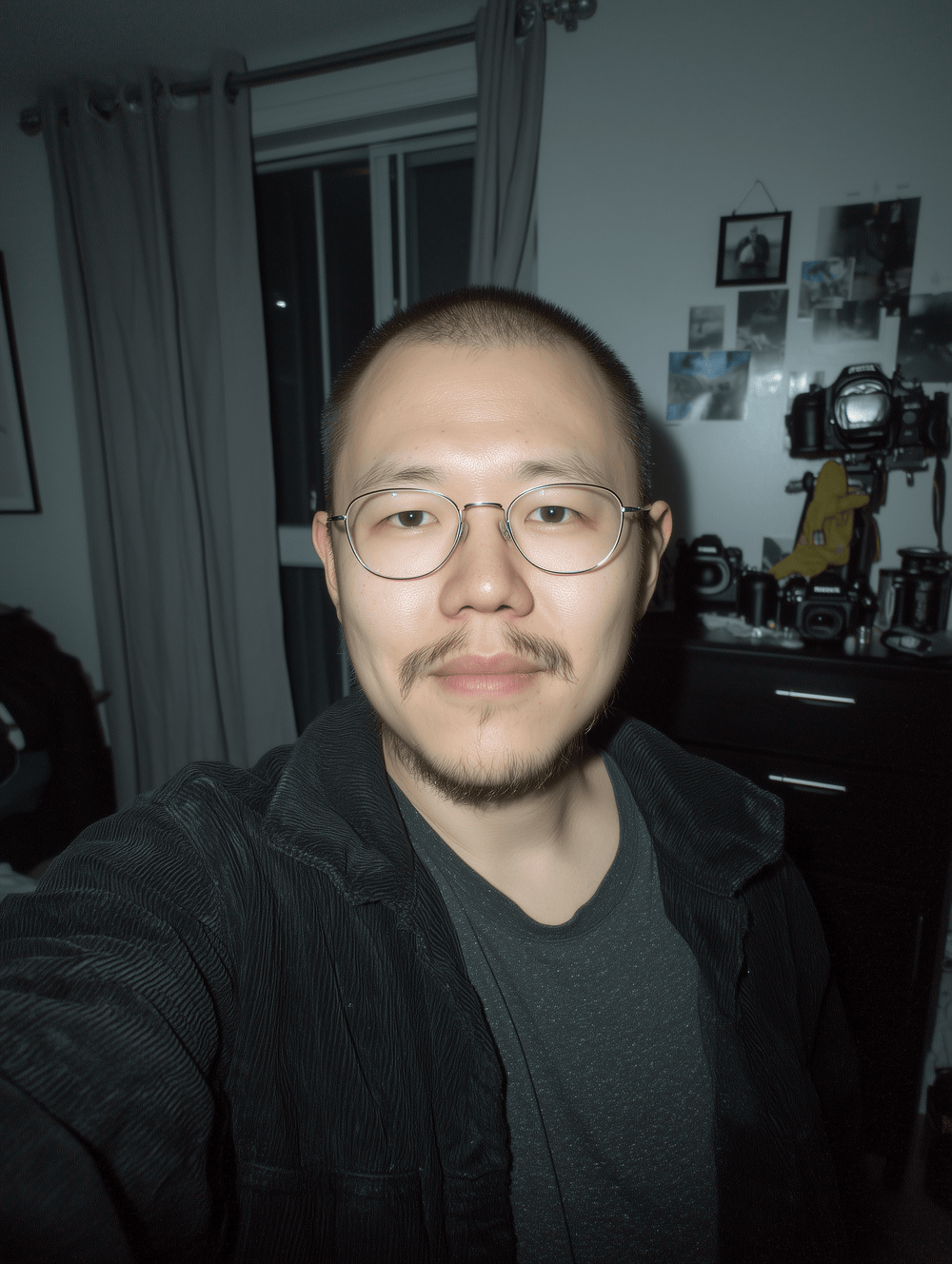 Asian man taking selfie in bedroom