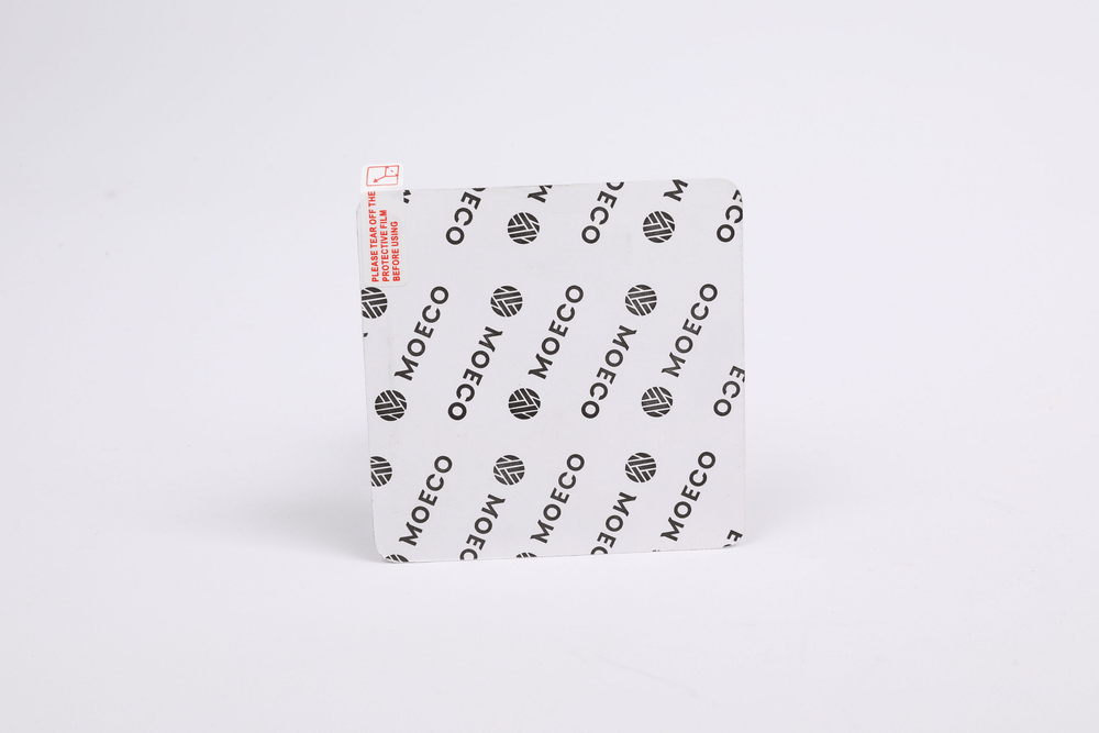 Adhesive back of GPS device on a white background