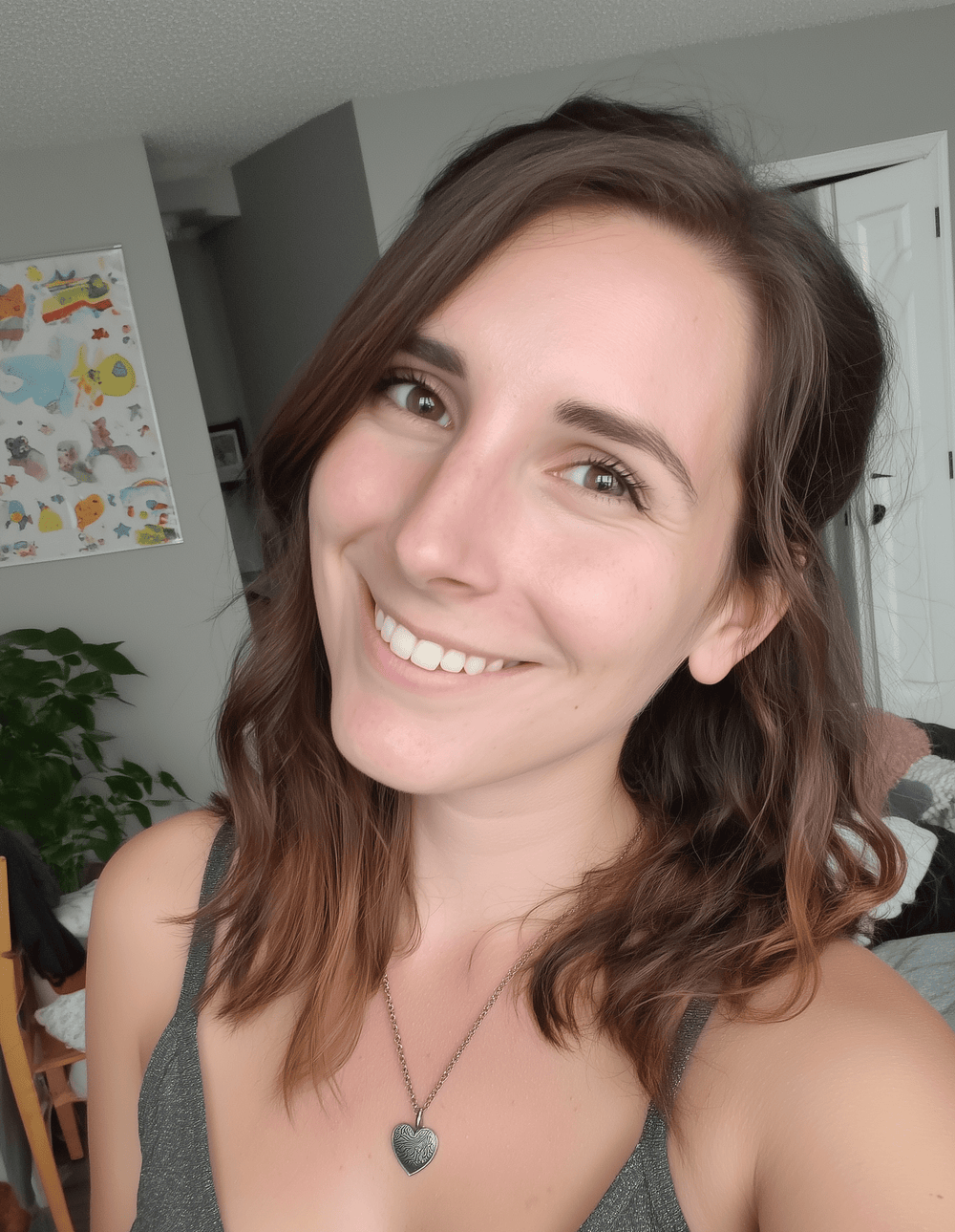 Woman with shoulder-length brown hair smiling indoors