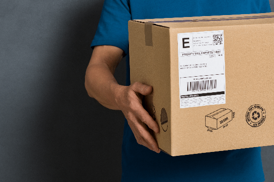 Courier delivering a cardboard package, representing shipment tracking and parcel monitoring solutions.