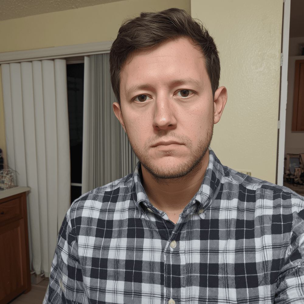 Man wearing a plaid shirt in an indoor setting