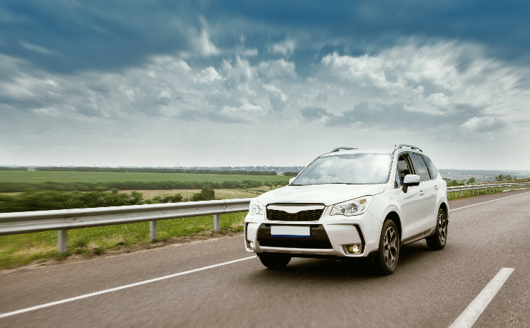 White SUV driving on a highway symbolizing real-time GPS vehicle tracking and fleet monitoring.